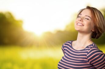 Young woman enjoying sun getting vitamin D